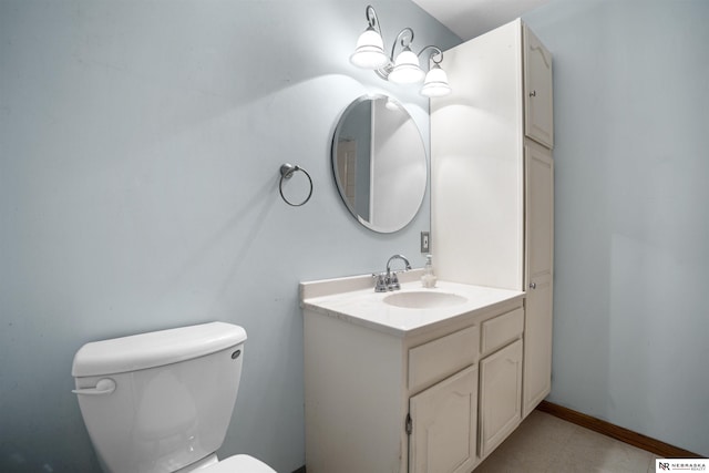 bathroom featuring toilet and vanity