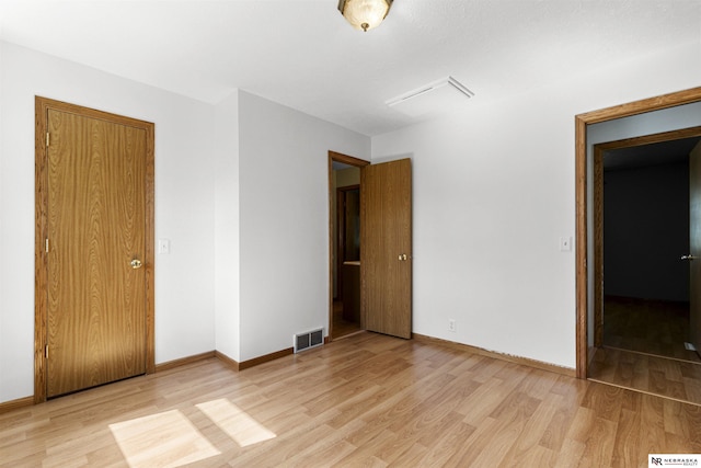 unfurnished bedroom featuring light wood-style flooring and baseboards