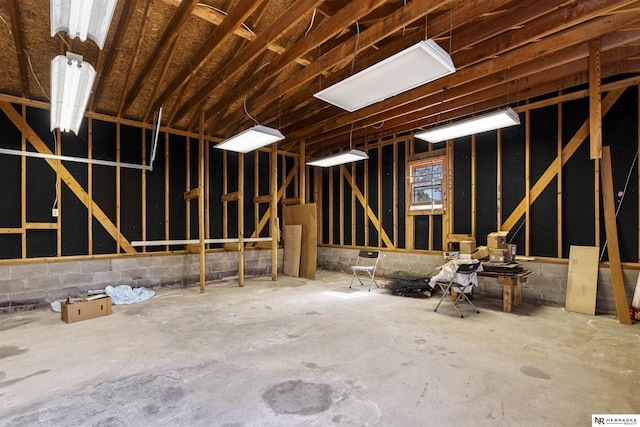 miscellaneous room with concrete flooring and a garage
