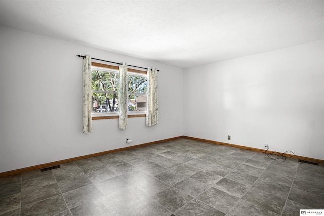 unfurnished room featuring baseboards
