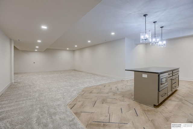 6511 Garvin St, Omaha, NE 68152 - interior space with stainless steel microwave, baseboards, pendant lighting, a kitchen island, and dark countertops