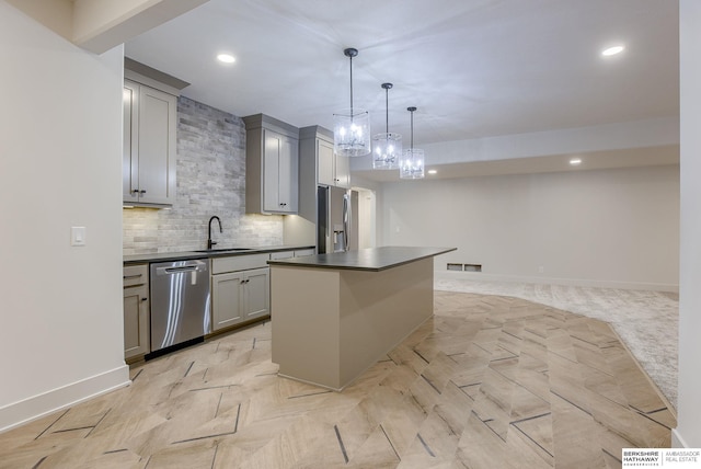 6511 Garvin St, Omaha, NE 68152 - kitchen with dark countertops, a sink, appliances with stainless steel finishes, and gray cabinetry