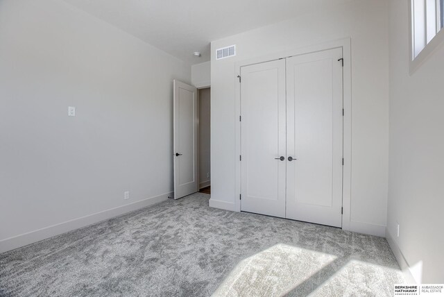 6511 Garvin St, Omaha, NE 68152 - unfurnished bedroom featuring carpet flooring, a closet, baseboards, and visible vents