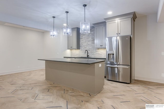 6511 Garvin St, Omaha, NE 68152 - kitchen with a sink, stainless steel fridge with ice dispenser, baseboards, backsplash, and a kitchen island
