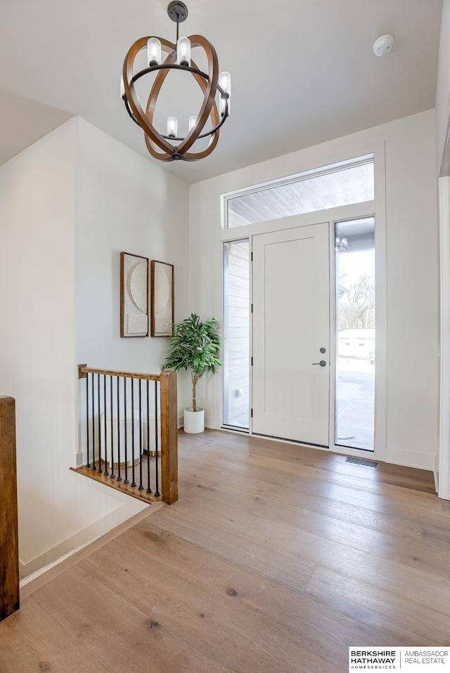 6511 Garvin St, Omaha, NE 68152 - foyer with a chandelier, wood finished floors, and baseboards