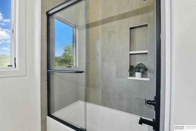 6511 Garvin St, Omaha, NE 68152 - bathroom featuring plenty of natural light and shower / bath combination with glass door