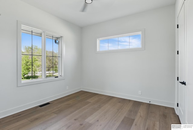 6511 Garvin St, Omaha, NE 68152 - spare room featuring visible vents, wood finished floors, baseboards, and ceiling fan