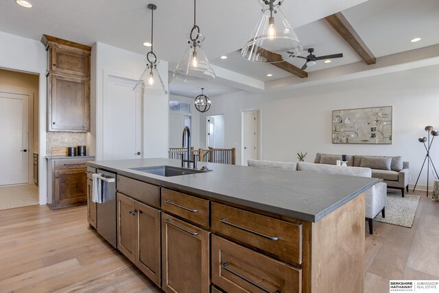 6511 Garvin St, Omaha, NE 68152 - kitchen with a sink, dishwasher, a center island with sink, beamed ceiling, and light wood-style floors