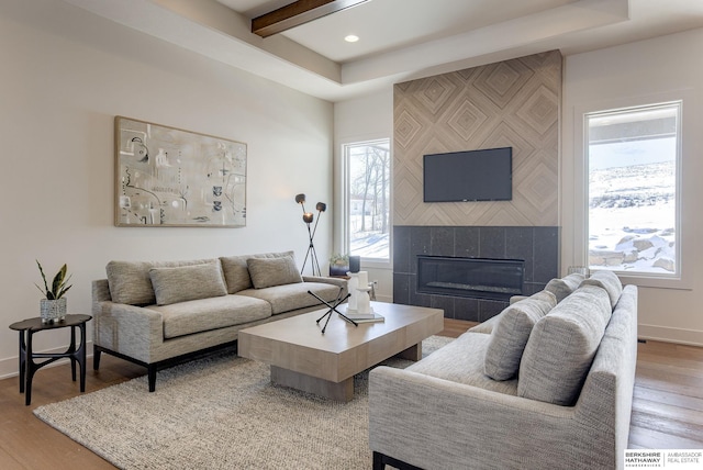 6511 Garvin St, Omaha, NE 68152 - living area with baseboards, wood finished floors, a fireplace, and recessed lighting