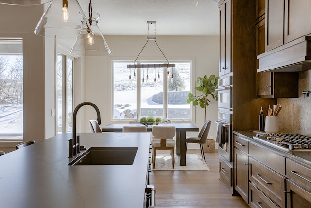 6511 Garvin St, Omaha, NE 68152 - kitchen with a wealth of natural light, appliances with stainless steel finishes, a sink, and wood finished floors
