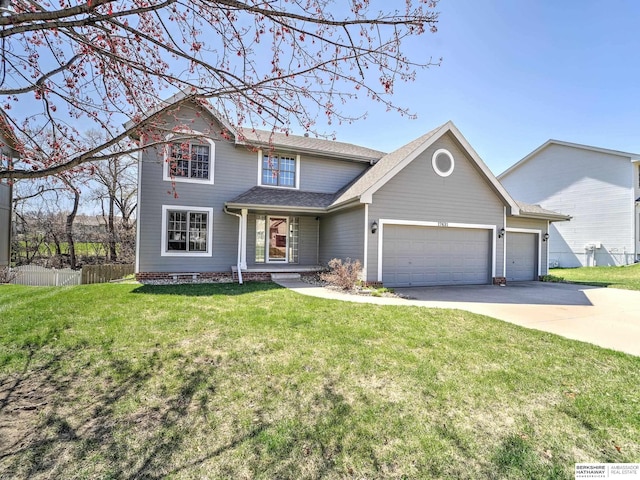 traditional-style house featuring a garage, fence, concrete driveway, and a front lawn
