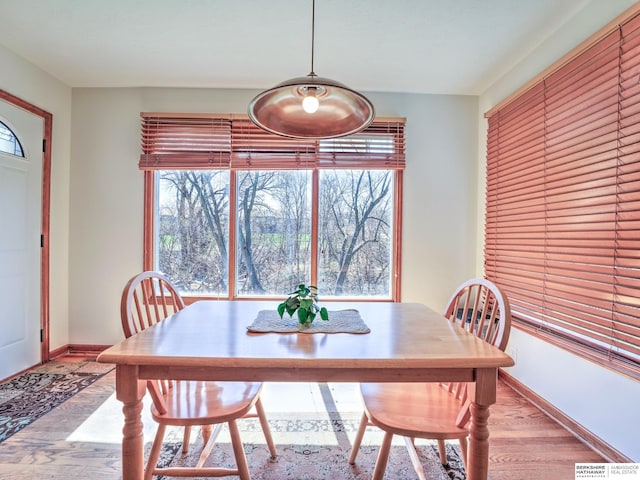 dining area with wood finished floors and baseboards