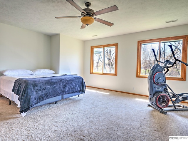 bedroom featuring carpet flooring, visible vents, baseboards, and ceiling fan