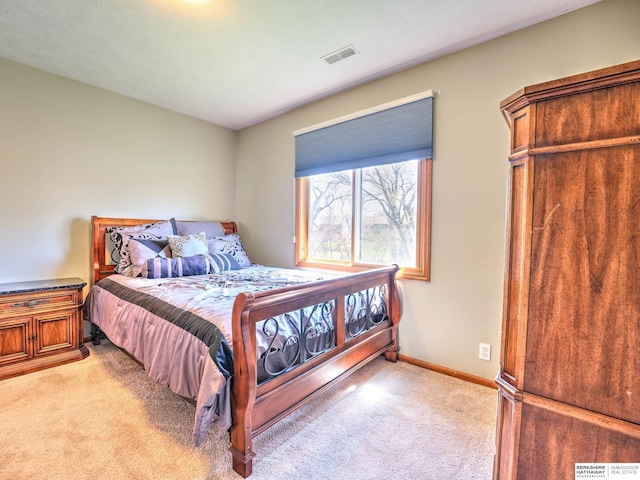 bedroom featuring light colored carpet, baseboards, and visible vents