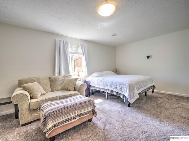 carpeted bedroom featuring visible vents, baseboards, and a textured ceiling
