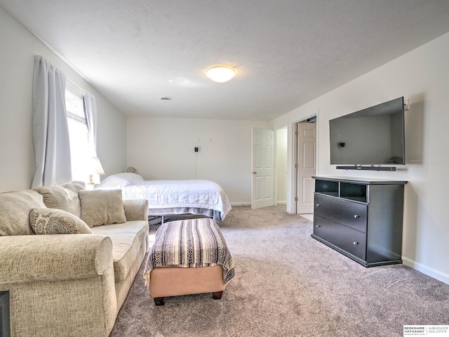 bedroom featuring a textured ceiling, baseboards, and carpet floors