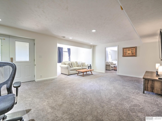 living area featuring baseboards, recessed lighting, carpet flooring, and a textured ceiling