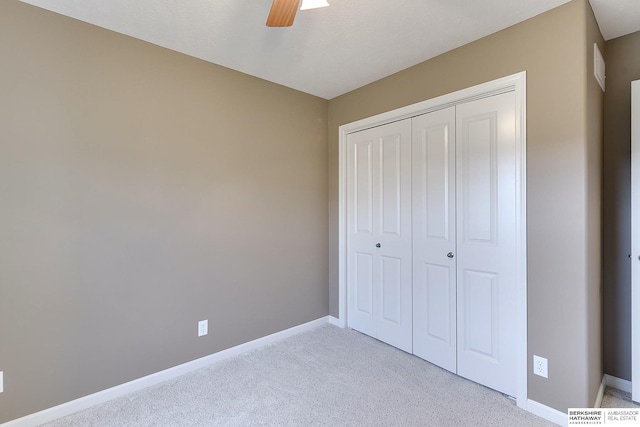 2857 Ravae Ln, Blair, NE 68008 - unfurnished bedroom featuring light carpet, a closet, ceiling fan, and baseboards