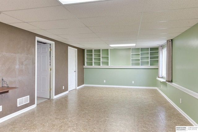 2857 Ravae Ln, Blair, NE 68008 - empty room featuring visible vents, built in features, a drop ceiling, and baseboards