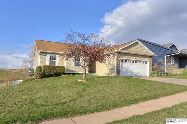 2857 Ravae Ln, Blair, NE 68008 - ranch-style house with concrete driveway, a front yard, central AC, and an attached garage