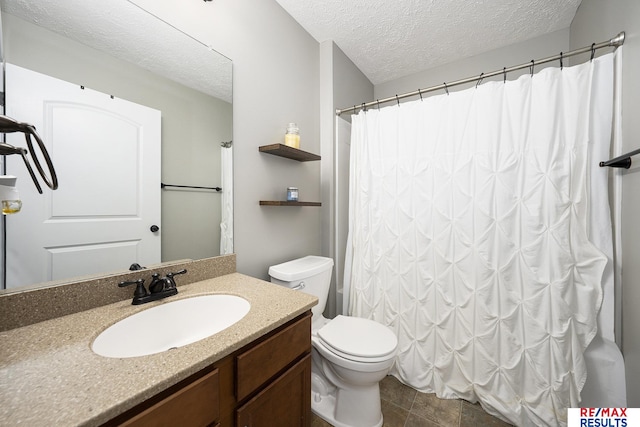 full bathroom with curtained shower, vanity, a textured ceiling, and toilet