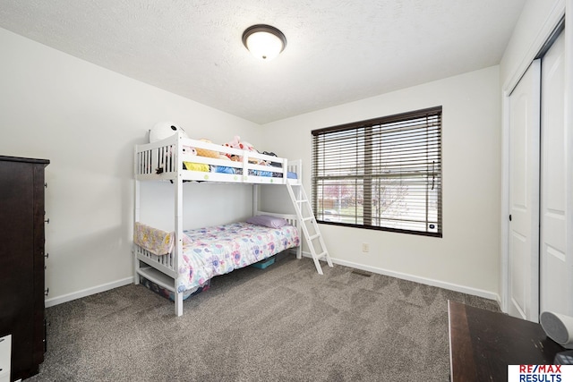 bedroom with carpet floors, a closet, and baseboards