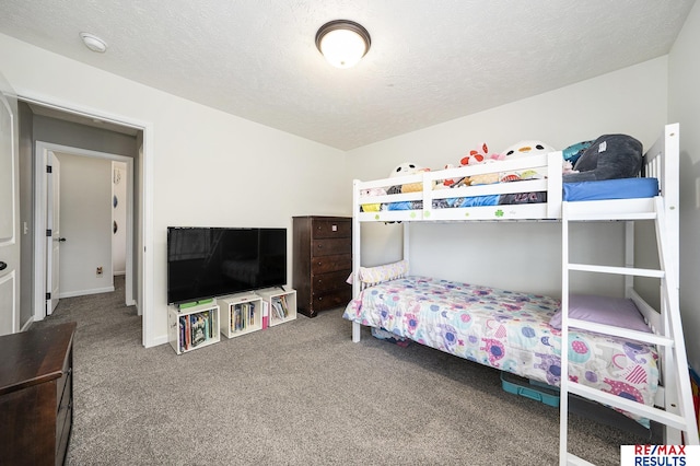 carpeted bedroom with a textured ceiling