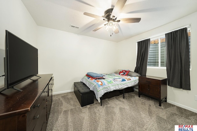 carpeted bedroom featuring ceiling fan, baseboards, and visible vents