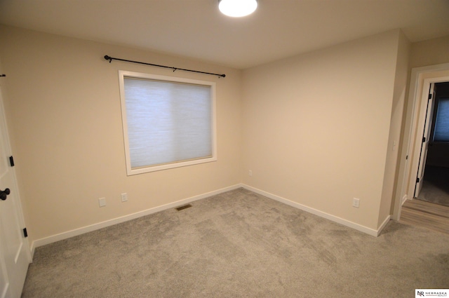 empty room with baseboards, carpet, and visible vents