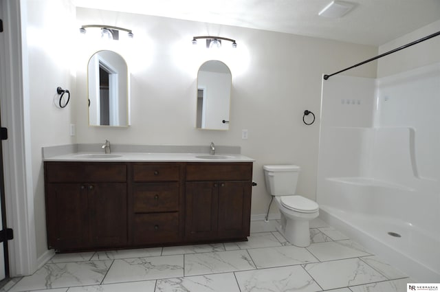 bathroom with toilet, marble finish floor, and a sink