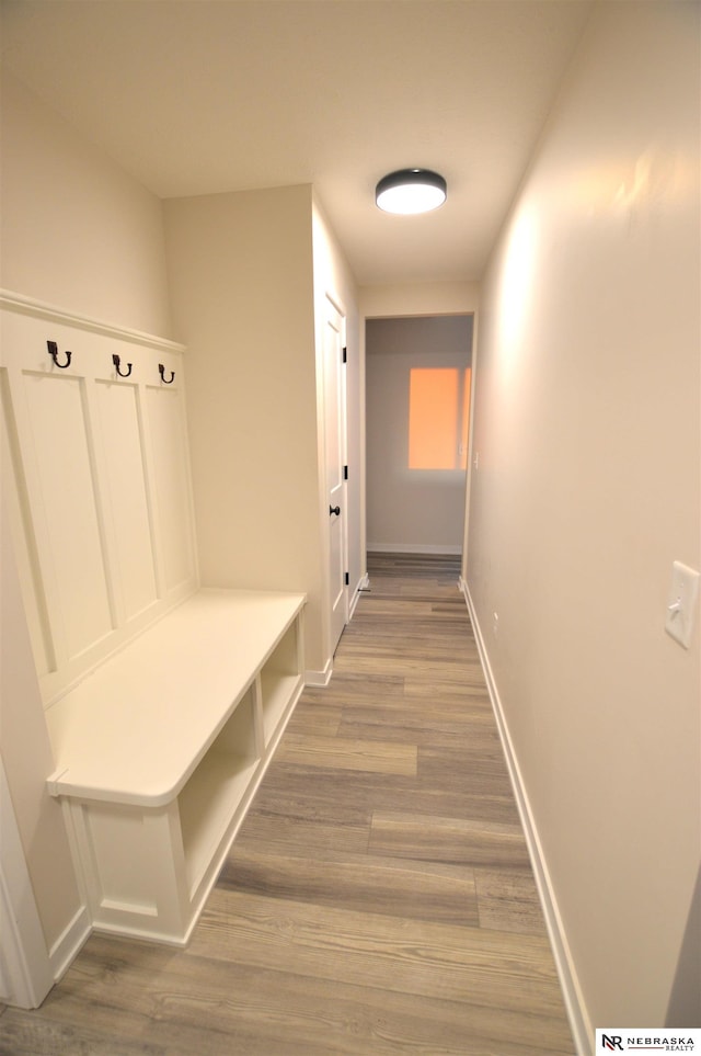 mudroom featuring baseboards and wood finished floors