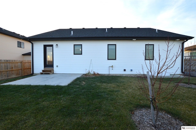 back of property featuring a patio, a yard, entry steps, and fence