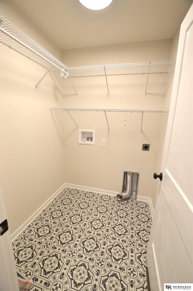clothes washing area with baseboards, electric dryer hookup, laundry area, and washer hookup