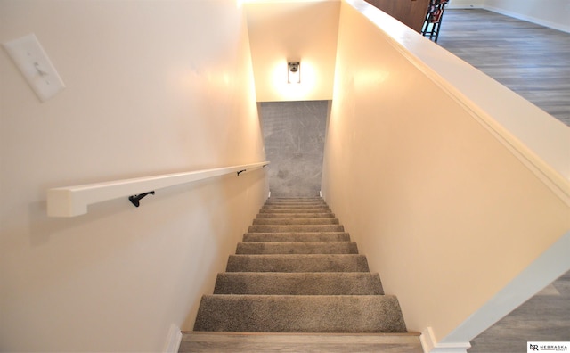 stairway featuring wood finished floors