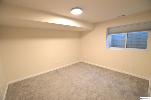 finished basement featuring visible vents, baseboards, and carpet