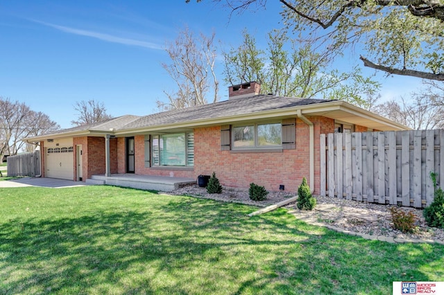 ranch-style home featuring a chimney, a front yard, brick siding, a garage, and fence
