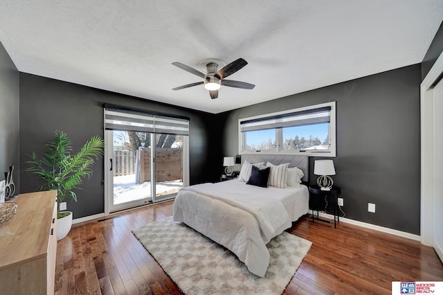 bedroom featuring hardwood / wood-style floors, access to exterior, ceiling fan, and baseboards