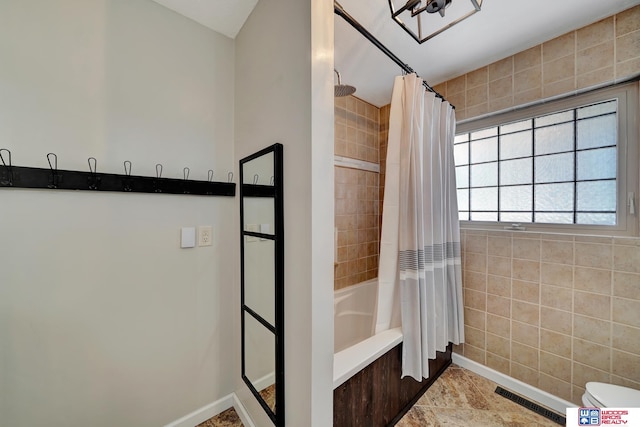 bathroom featuring shower / tub combo, baseboards, and visible vents