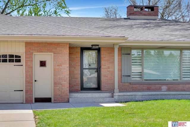 property entrance featuring a garage, brick siding, a chimney, and a shingled roof