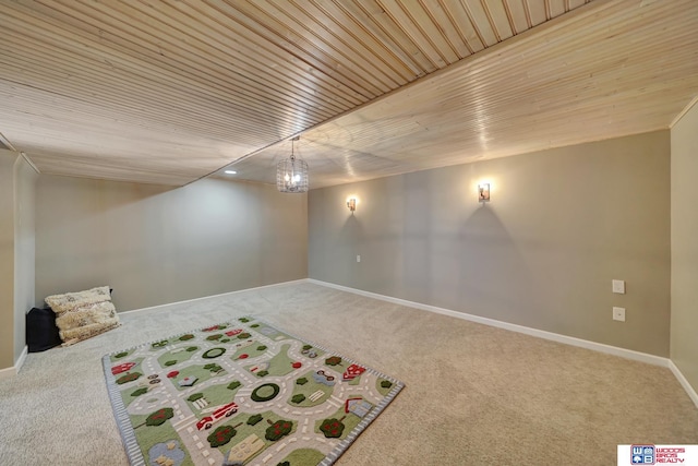 finished basement featuring wood ceiling, baseboards, and carpet floors