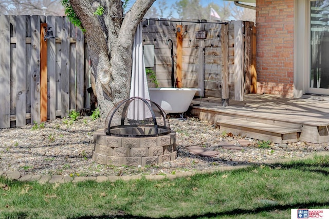 exterior space with a fire pit and fence