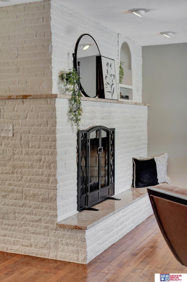 interior details featuring wood finished floors and a fireplace