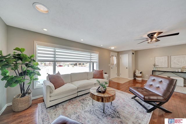 living room featuring wood finished floors, ceiling fan, baseboards, and recessed lighting