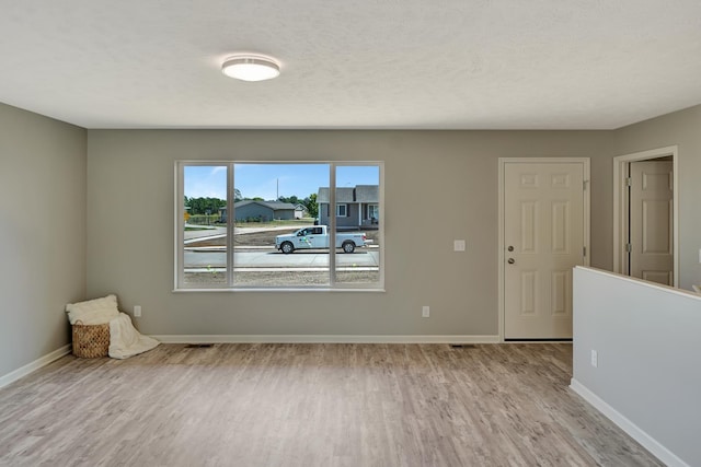interior space featuring wood finished floors and baseboards