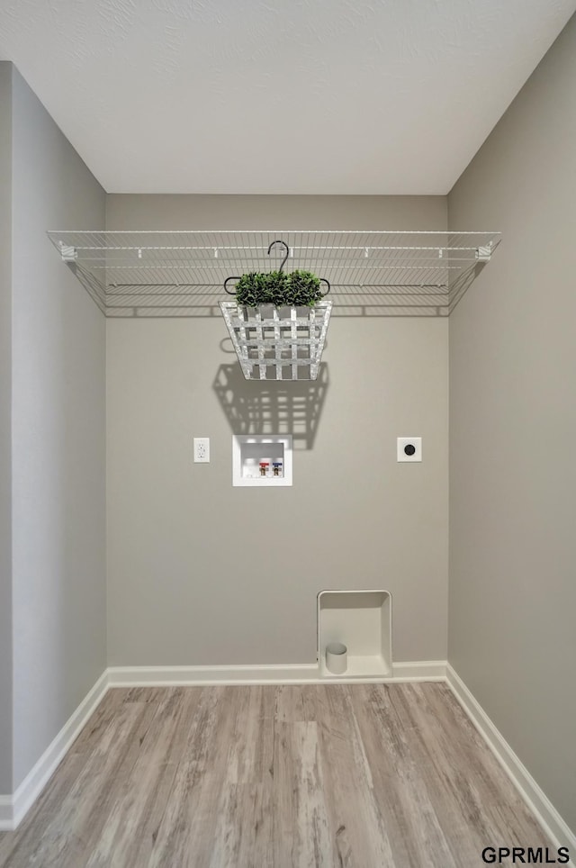 washroom with baseboards, washer hookup, laundry area, light wood finished floors, and electric dryer hookup