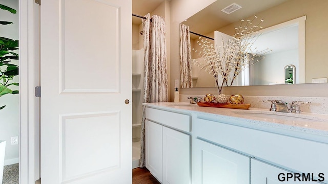 11502 Port Royal Dr, Papillion, NE 68046 - full bathroom featuring double vanity, a sink, visible vents, and a shower with curtain