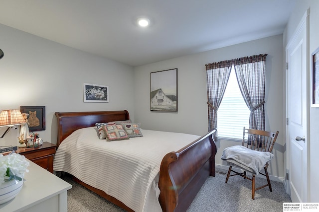 bedroom with light carpet and baseboards
