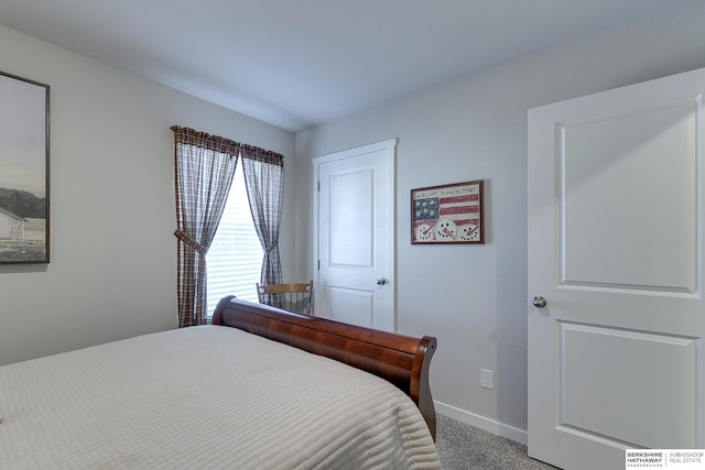 carpeted bedroom with baseboards