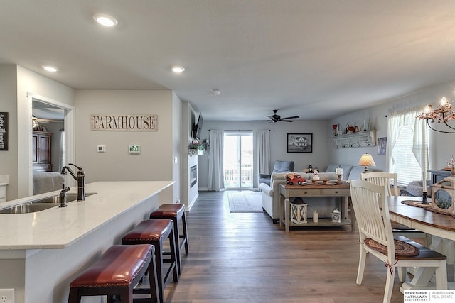 dining room with dark wood-type flooring, ceiling fan, and recessed lighting