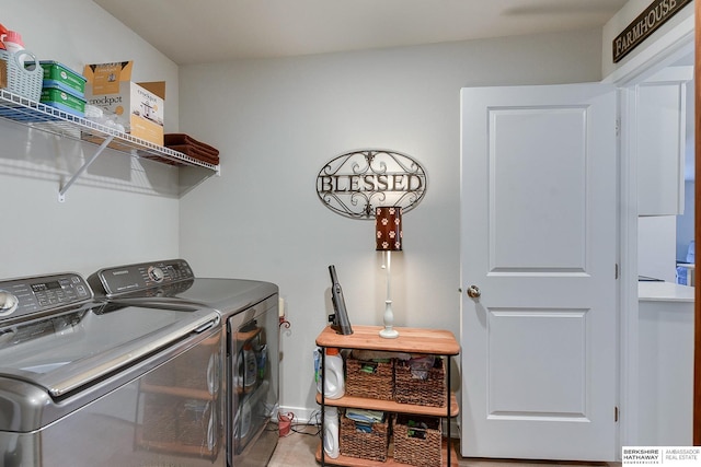 laundry area with baseboards, laundry area, and washing machine and clothes dryer